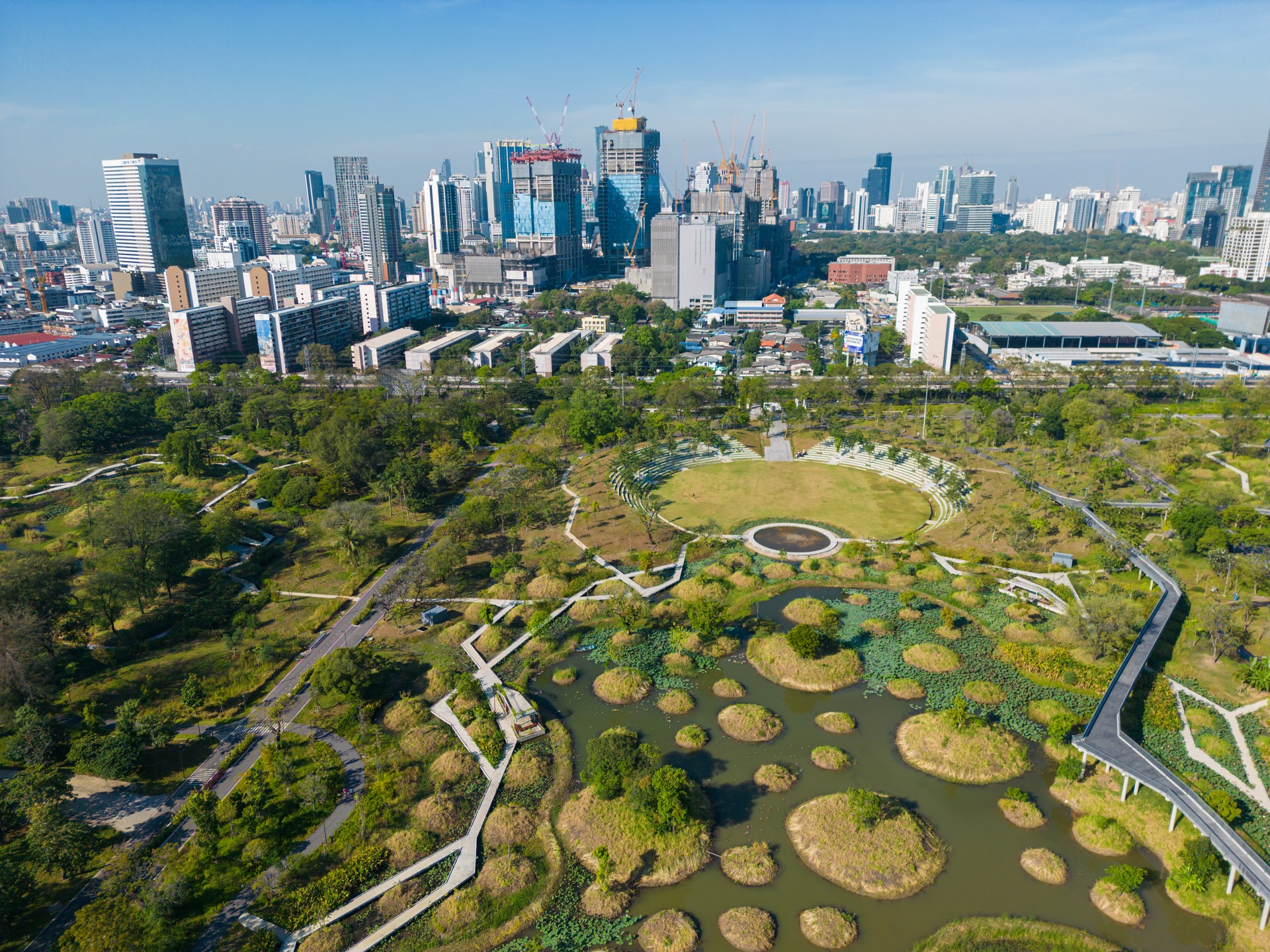 Benjakitti Forest public Park new landmark of central Bangkok with office building aerial view